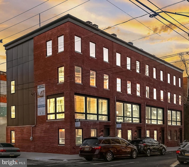 view of outdoor building at dusk