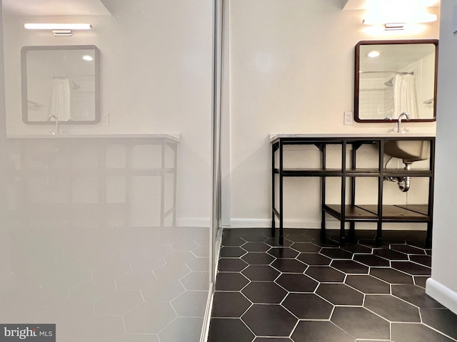 bathroom with tile patterned flooring, sink, and curtained shower