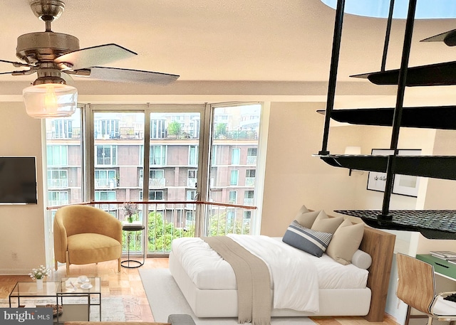 bedroom with multiple windows and light hardwood / wood-style floors