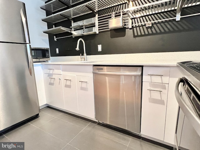 kitchen featuring white cabinets, appliances with stainless steel finishes, and sink