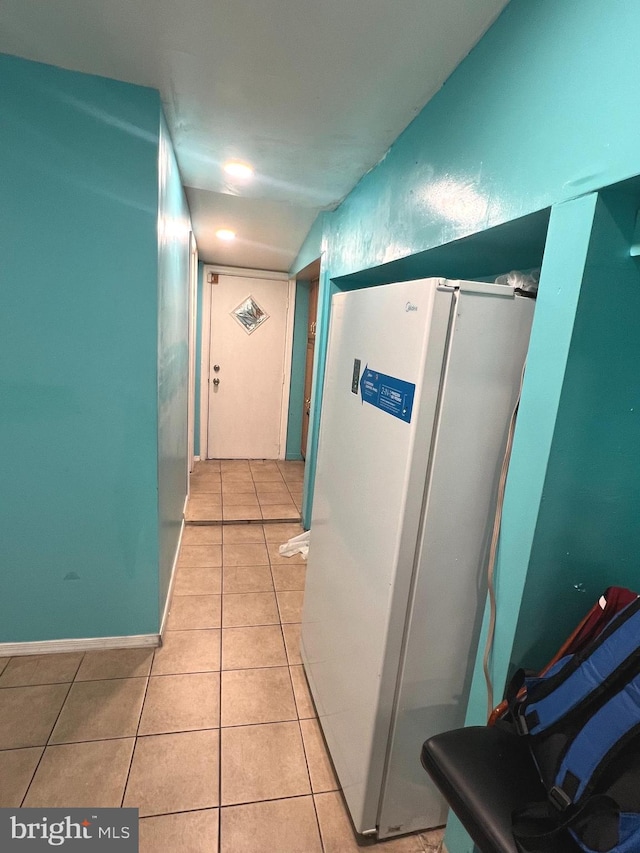 hallway featuring light tile patterned flooring