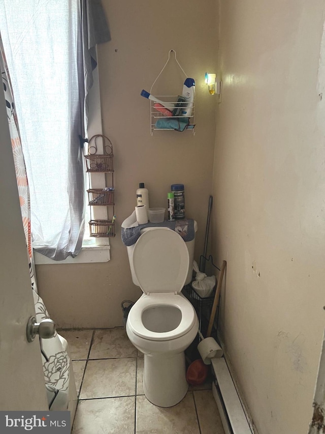 bathroom with toilet and tile patterned floors