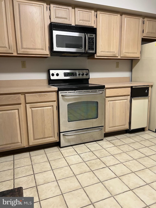 kitchen with appliances with stainless steel finishes, light brown cabinets, and light countertops