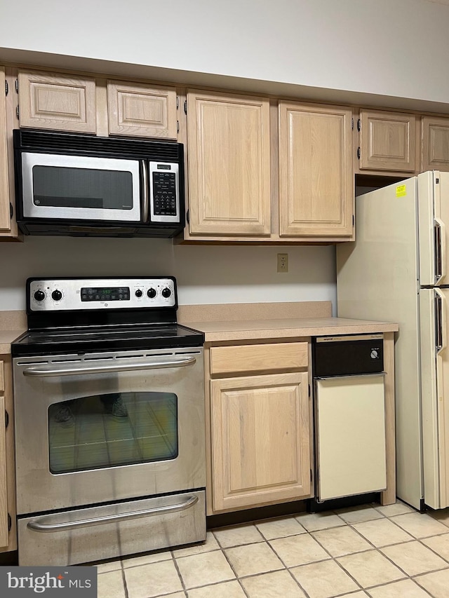 kitchen with light tile patterned flooring, light brown cabinets, stainless steel appliances, and light countertops