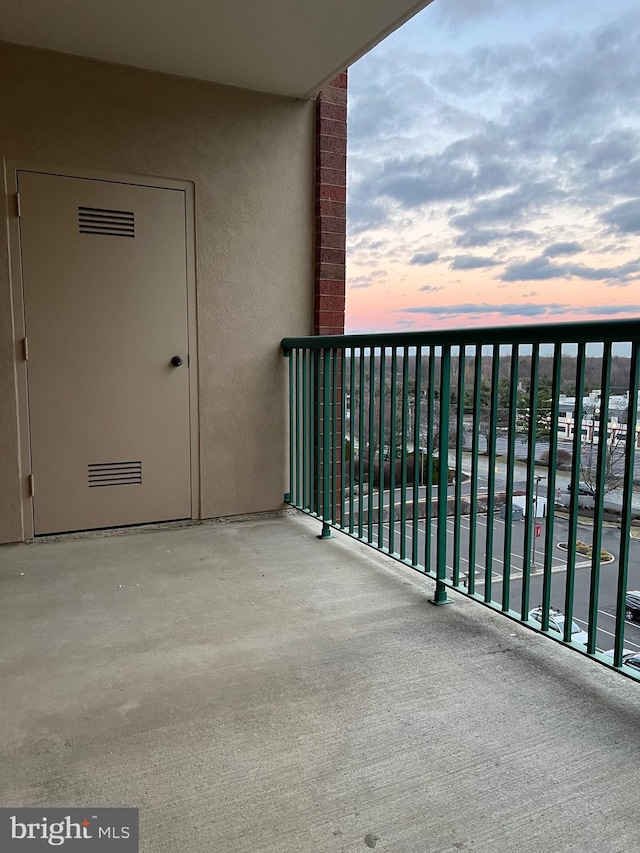 view of balcony at dusk