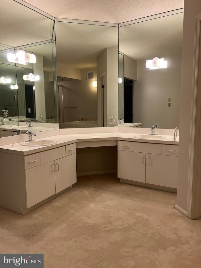 bathroom featuring vanity, visible vents, and a textured ceiling