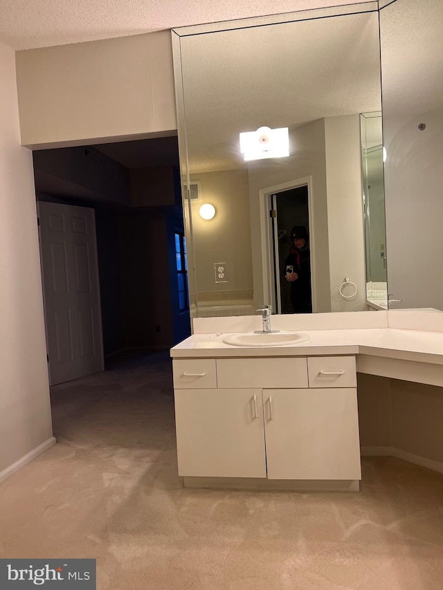 bathroom with visible vents, baseboards, a textured ceiling, and vanity