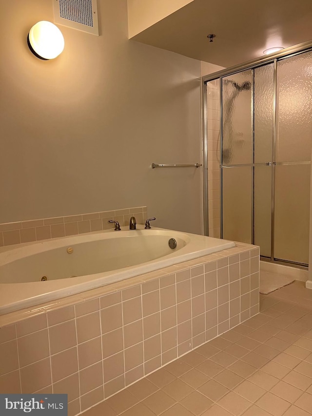 bathroom with visible vents, a shower stall, and a whirlpool tub