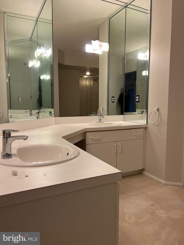 full bathroom featuring baseboards and vanity