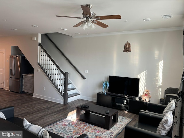 living room featuring dark wood-type flooring, ceiling fan, and ornamental molding