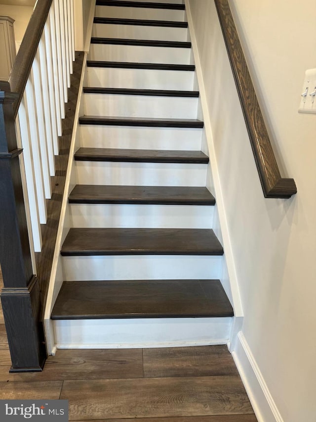 staircase featuring hardwood / wood-style floors