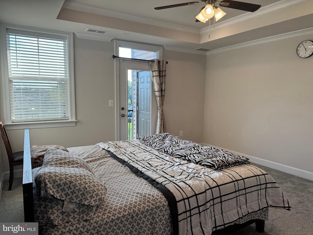 carpeted bedroom featuring a tray ceiling, ornamental molding, access to outside, and ceiling fan