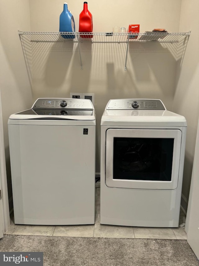 laundry area featuring tile patterned floors and separate washer and dryer