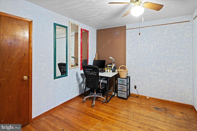 office space featuring ceiling fan, hardwood / wood-style floors, and a textured ceiling