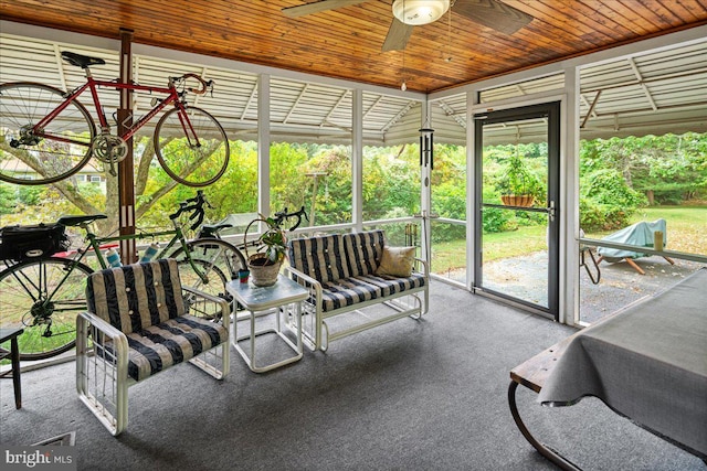 sunroom / solarium with wood ceiling and ceiling fan