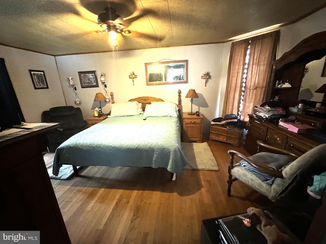 bedroom with hardwood / wood-style floors and ceiling fan