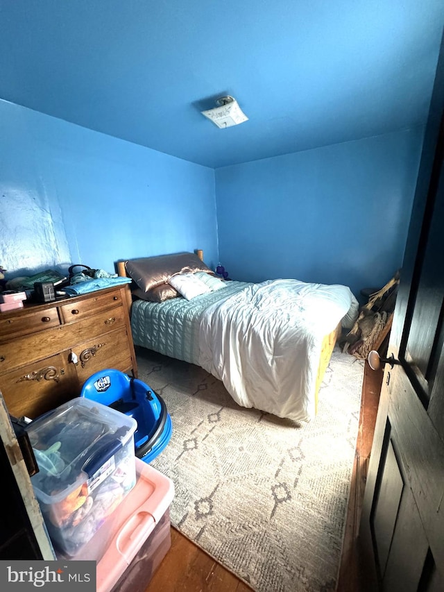 bedroom with dark wood-type flooring