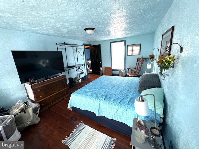 bedroom featuring a textured ceiling and wood-type flooring