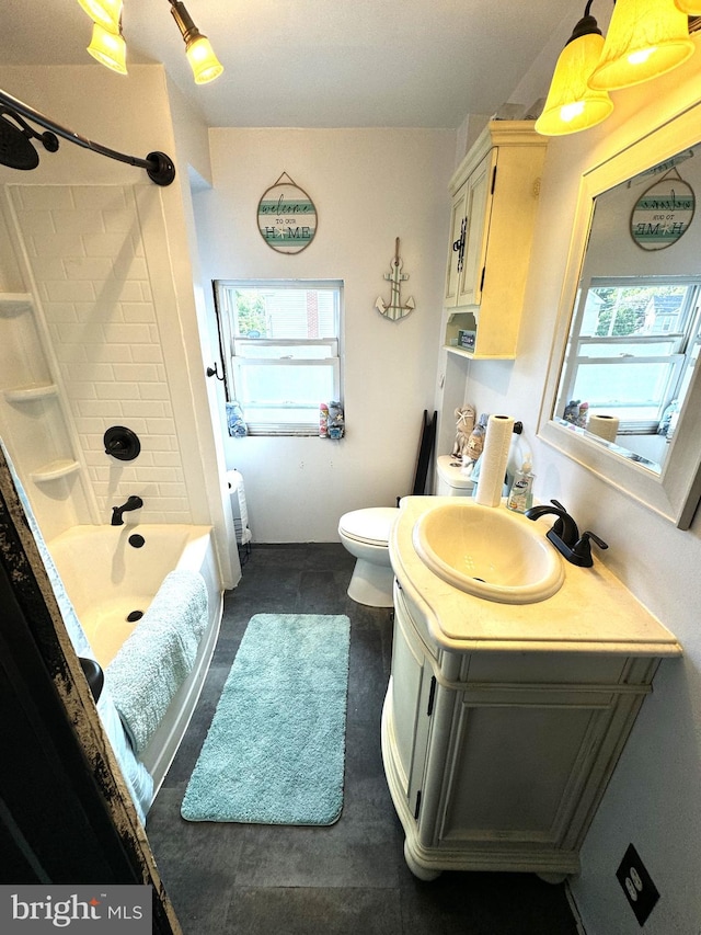 full bathroom with a healthy amount of sunlight, toilet, shower / washtub combination, and vanity