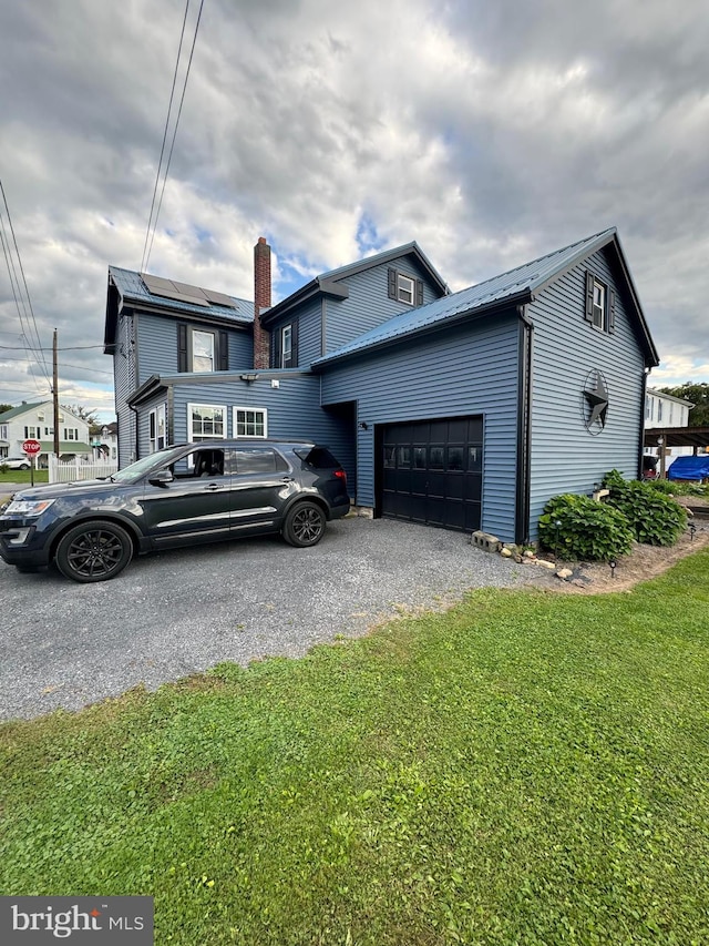 view of front facade with a garage and a front lawn