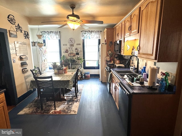 kitchen featuring dark hardwood / wood-style flooring, stainless steel appliances, sink, and ceiling fan