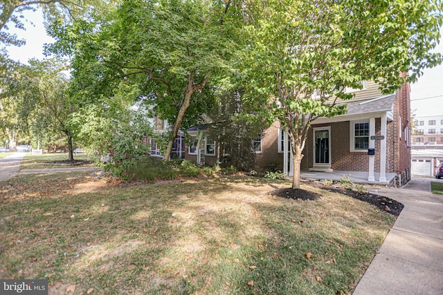 view of front of house with a garage and a front lawn