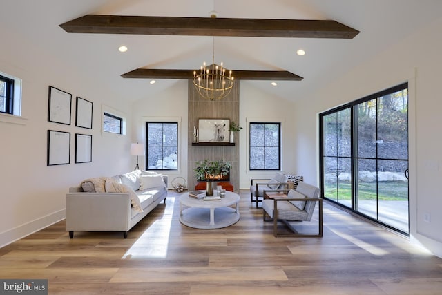 living room featuring beamed ceiling, hardwood / wood-style floors, a chandelier, and high vaulted ceiling