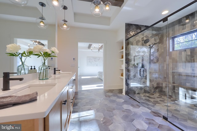 bathroom featuring vanity, an enclosed shower, and a tray ceiling