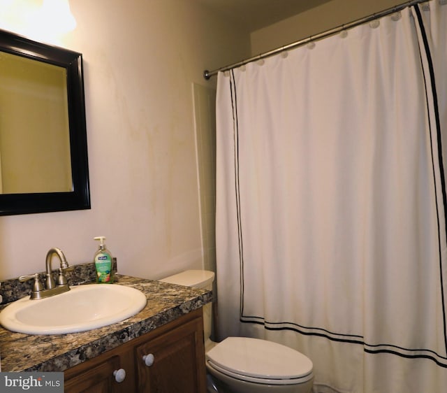 bathroom with vanity, toilet, and a shower with curtain