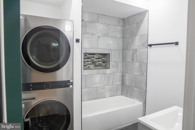 full bathroom featuring stacked washer and dryer