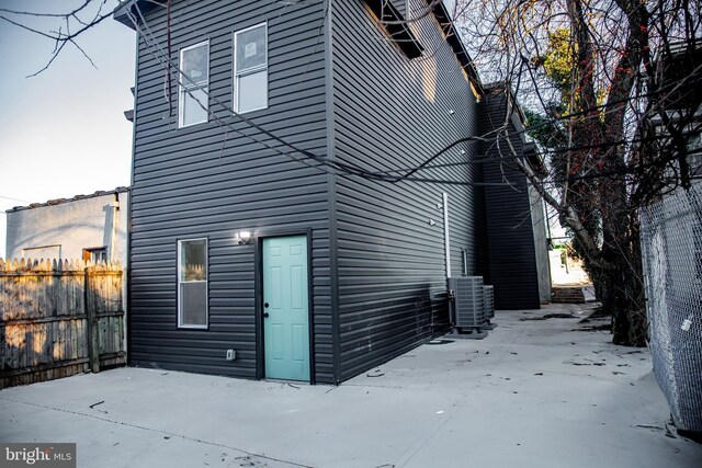 view of side of property featuring a patio area and central air condition unit