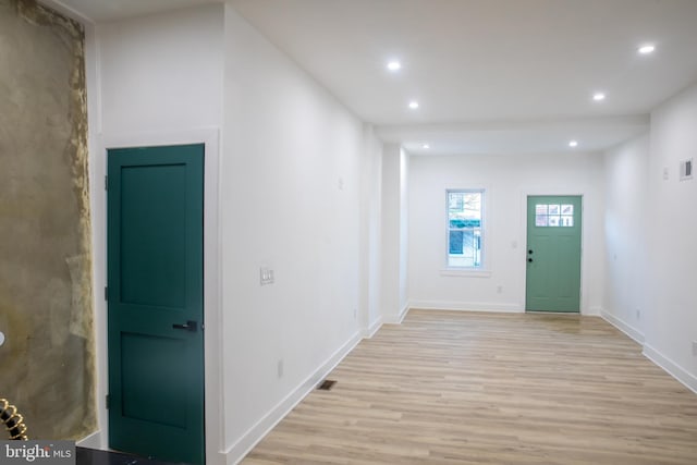 foyer entrance featuring visible vents, recessed lighting, light wood-type flooring, and baseboards