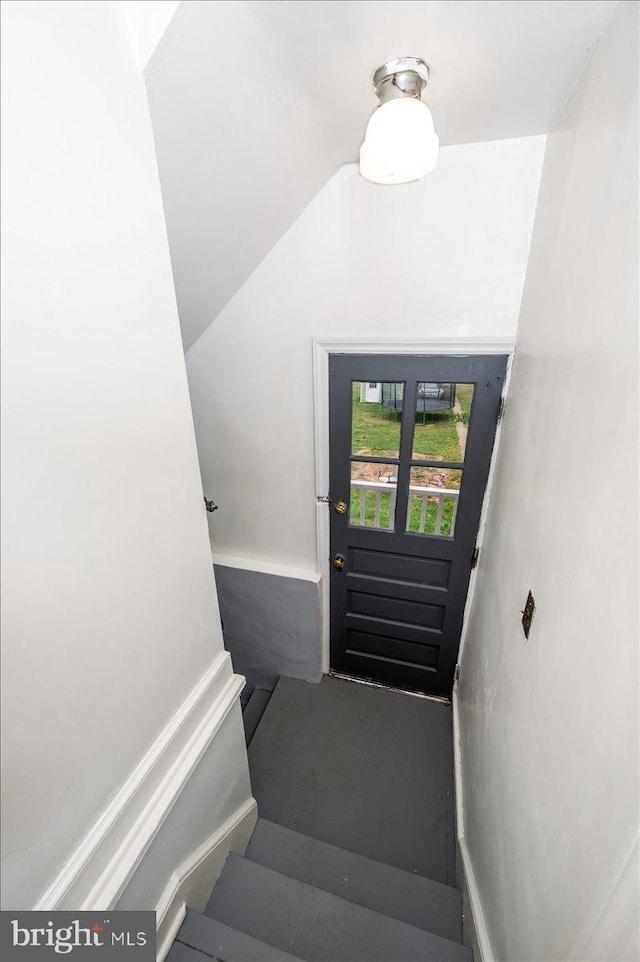 stairs with vaulted ceiling