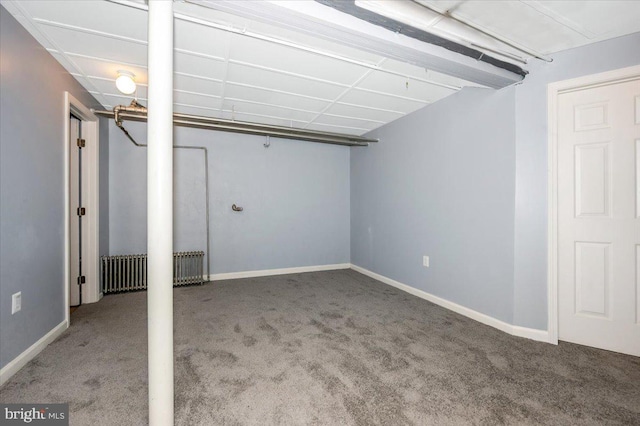 basement featuring carpet floors and radiator heating unit