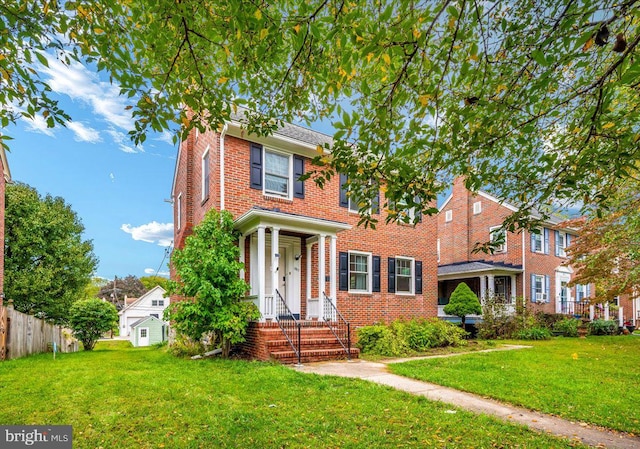 colonial inspired home with a front lawn