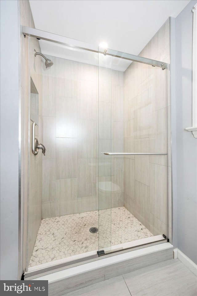 bathroom with a shower with shower door