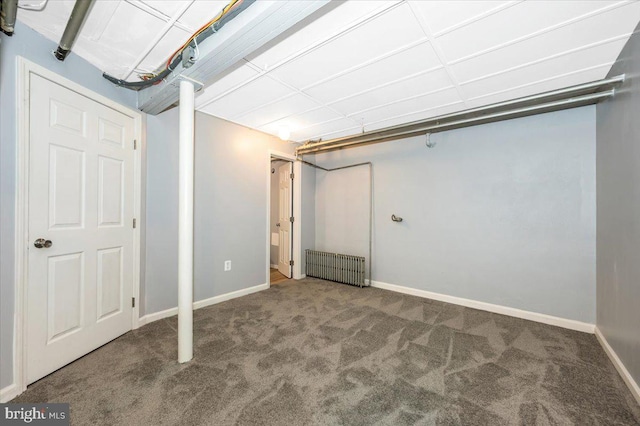 basement with radiator heating unit and carpet floors