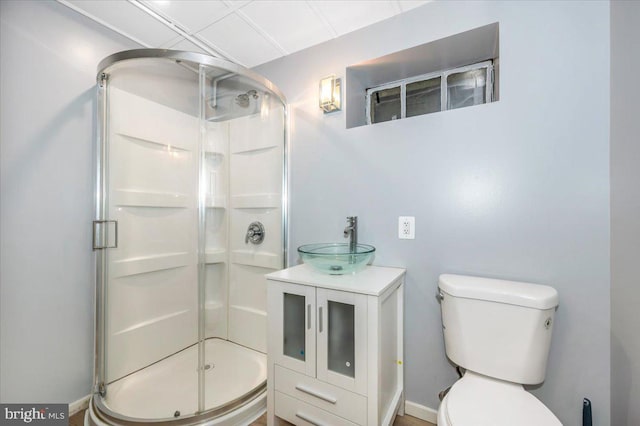 bathroom featuring vanity, toilet, and a shower with shower door