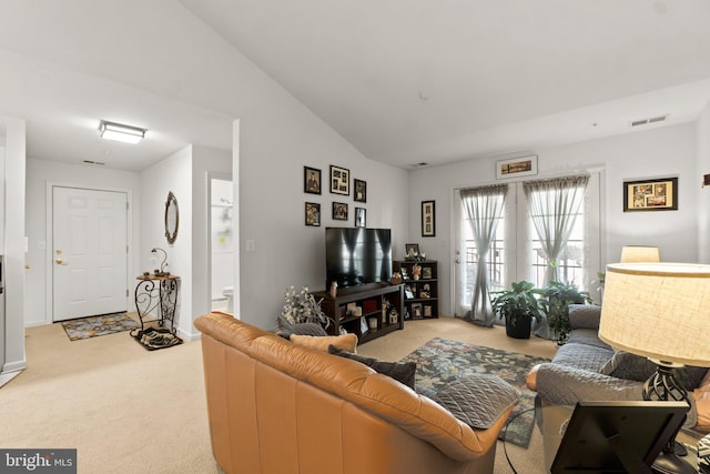 living room featuring vaulted ceiling and light colored carpet