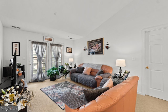 carpeted living room featuring vaulted ceiling