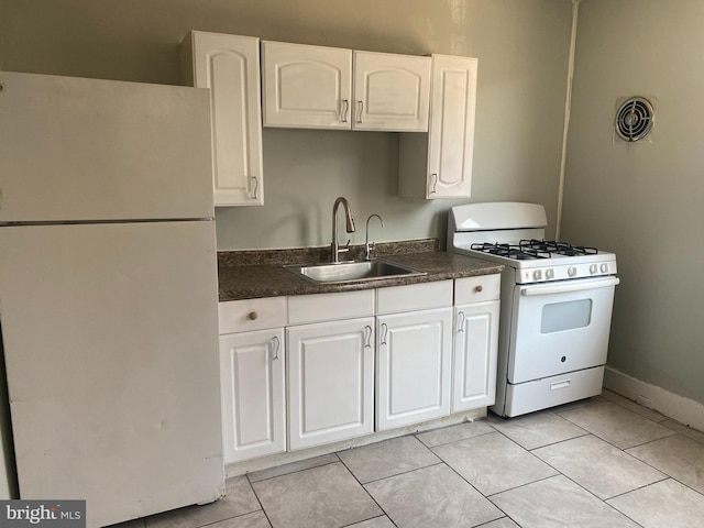 kitchen featuring white cabinets, white appliances, light tile patterned floors, and sink