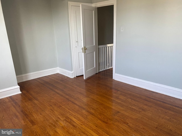 unfurnished room featuring dark hardwood / wood-style floors