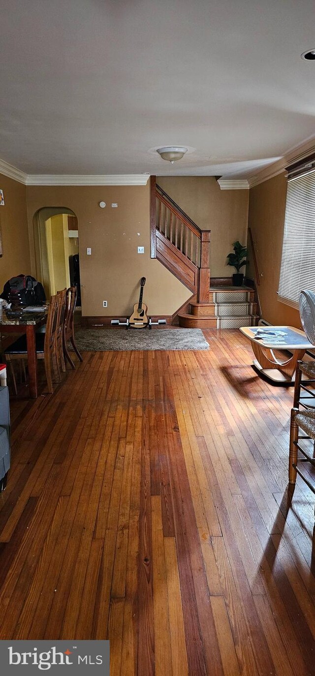 interior space featuring crown molding and hardwood / wood-style floors