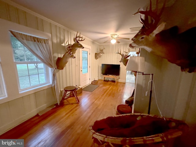 additional living space featuring light wood-type flooring and ceiling fan