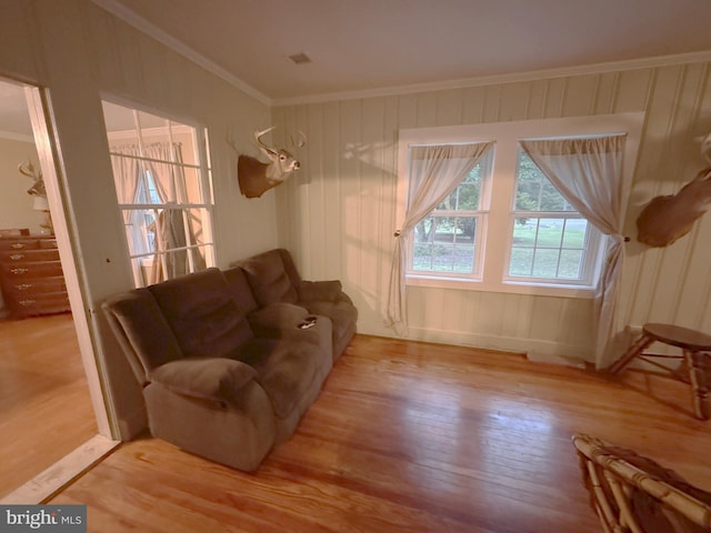 living room with ornamental molding and hardwood / wood-style floors