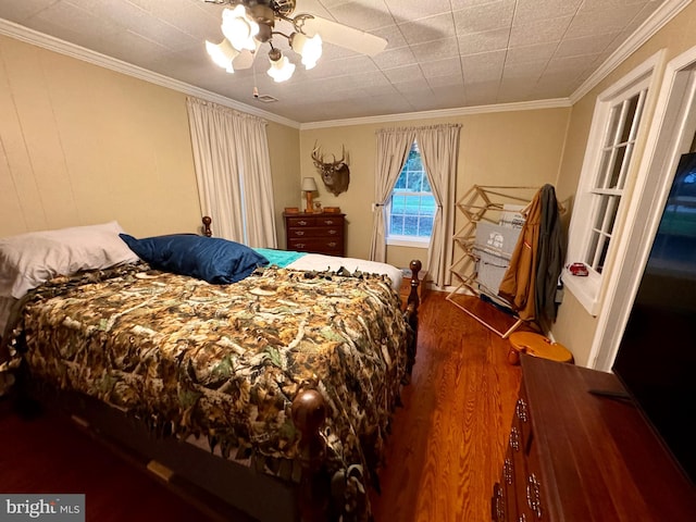 bedroom featuring ornamental molding, ceiling fan, and dark hardwood / wood-style floors