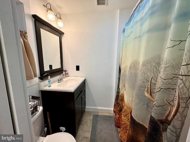 bathroom with vanity and toilet