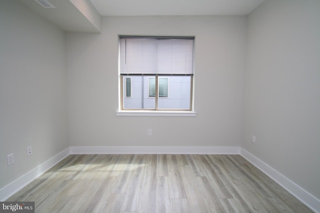 unfurnished room with light wood-type flooring