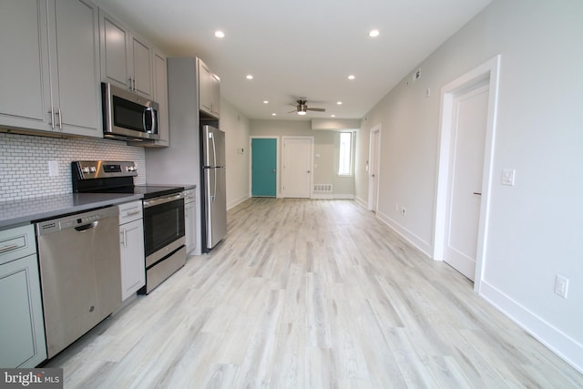 kitchen featuring appliances with stainless steel finishes, gray cabinetry, light wood-type flooring, and ceiling fan