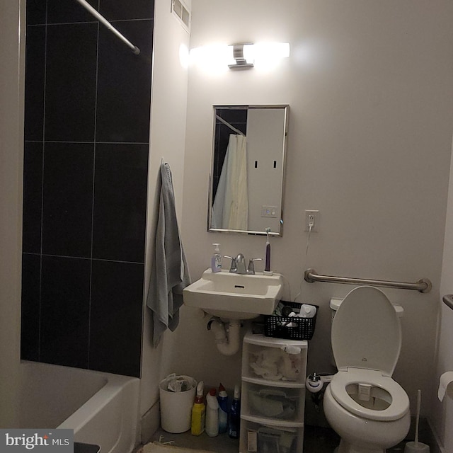 full bathroom with shower / bath combo, sink, and toilet